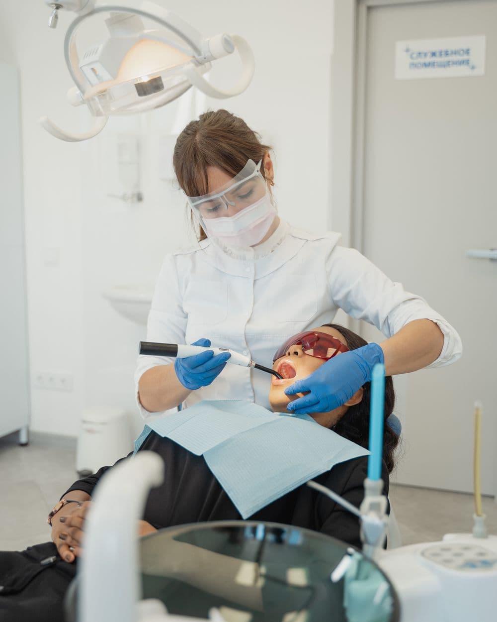 Sports dentist examining an athlete chair-side.